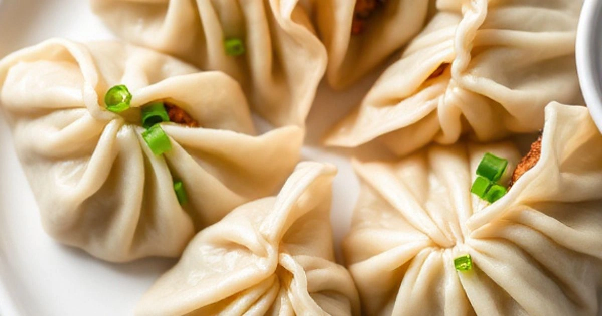 Delicious Pork Chive Dumplings served on a plate with dipping sauce.