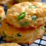 Close-up of stacked Cheesy Jalapeño Shortbread with visible jalapeño slices and golden, crispy edges