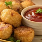 Golden brown cauliflower tots served with tomato dipping sauce, perfect gluten-free and keto-friendly snack option.