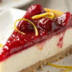 Cherry Lemon Cheesecake slice with cherry topping and lemon zest on graham cracker crust