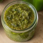 Fresh homemade Puerto Rican sofrito recipe in a glass jar with garlic and herbs